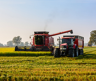 Havester and Tractor in field